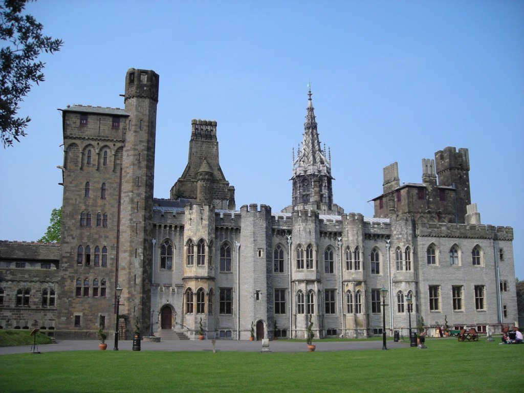Cardiff Castle. A grey stone building with lawn in front.